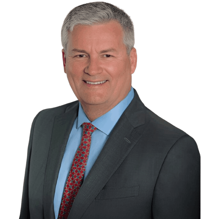 Professional man in a suit and red tie smiling at the camera.